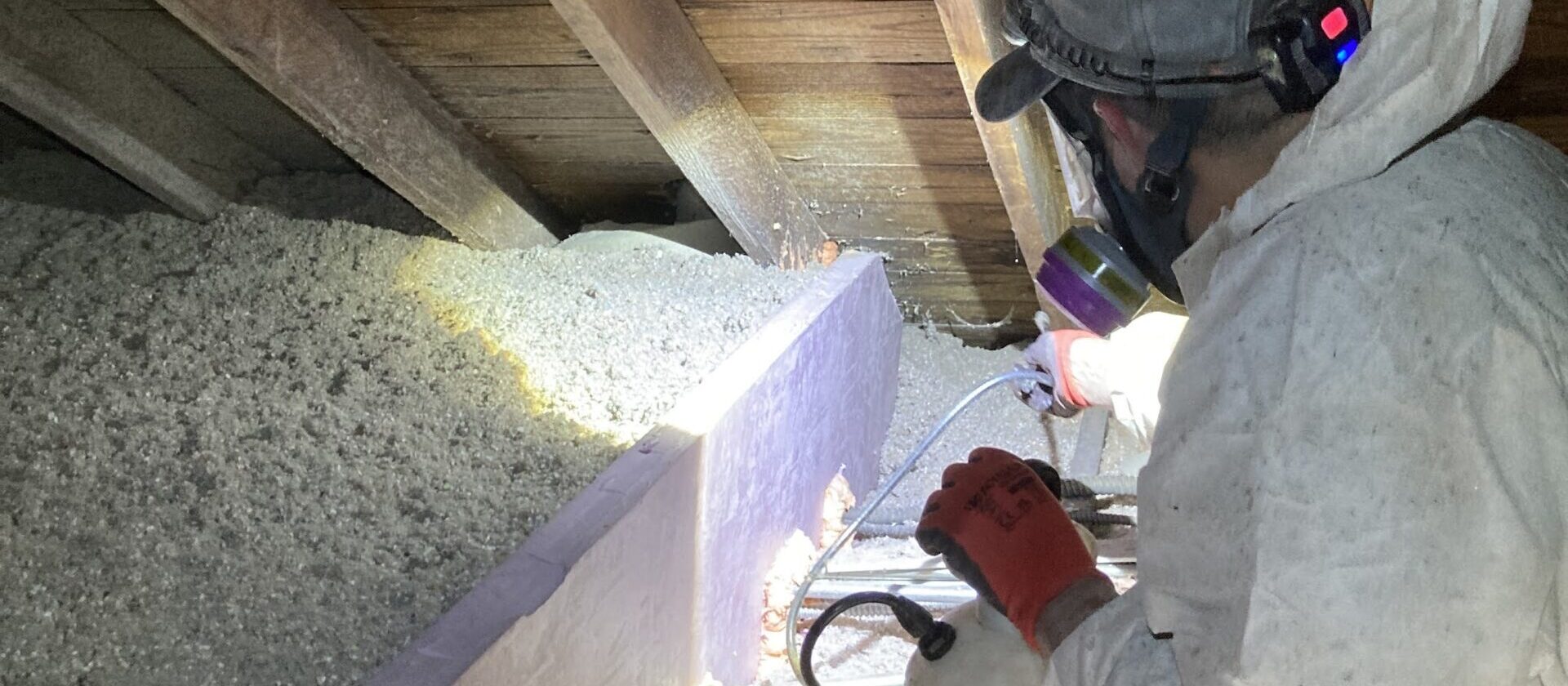 man treating mold in an attic